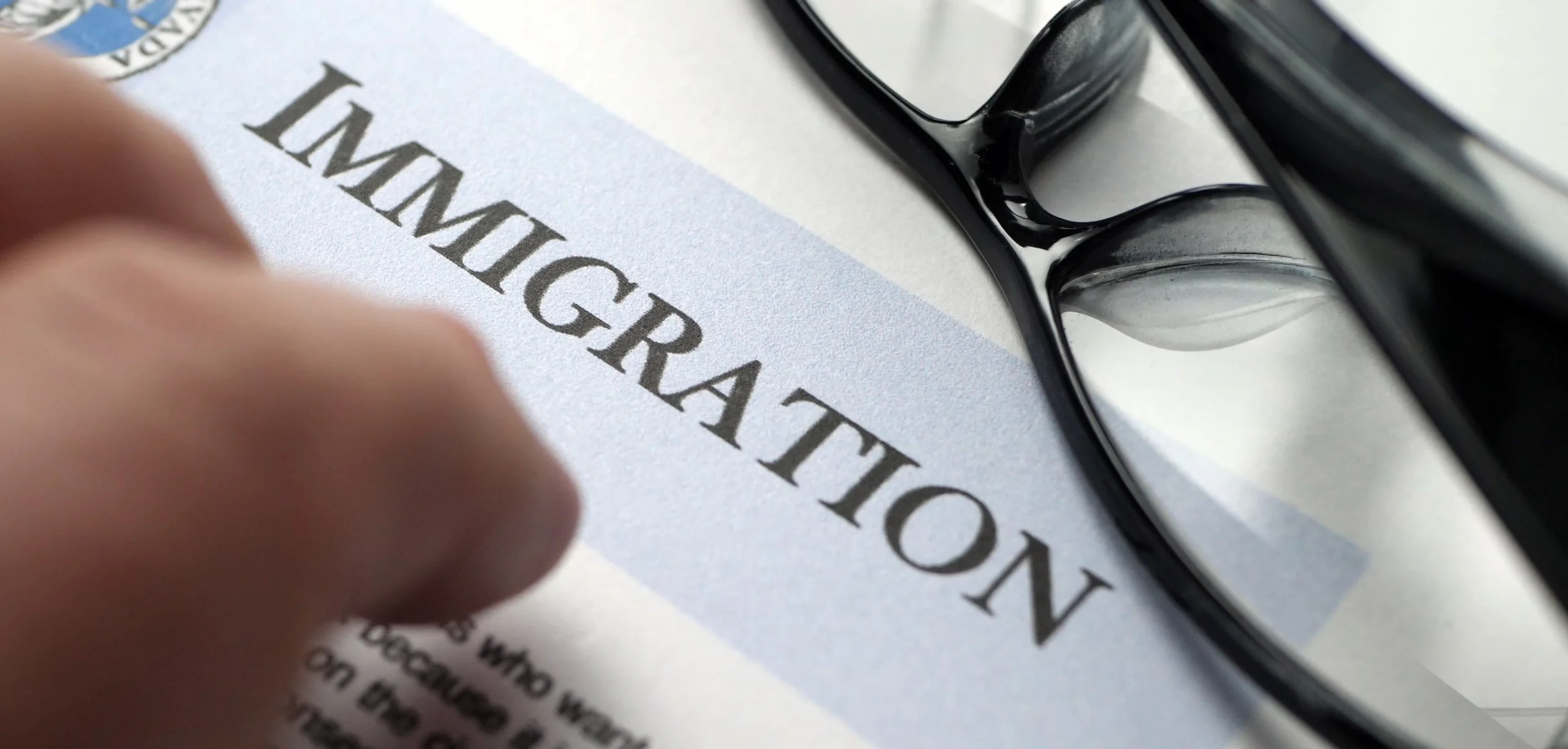 86276064 finger tapping on immigration document