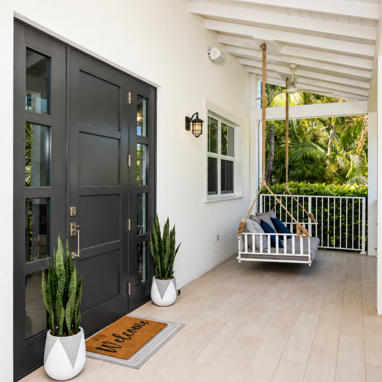 20261005143107 Bright Coastal Porch with Swing and Greenery