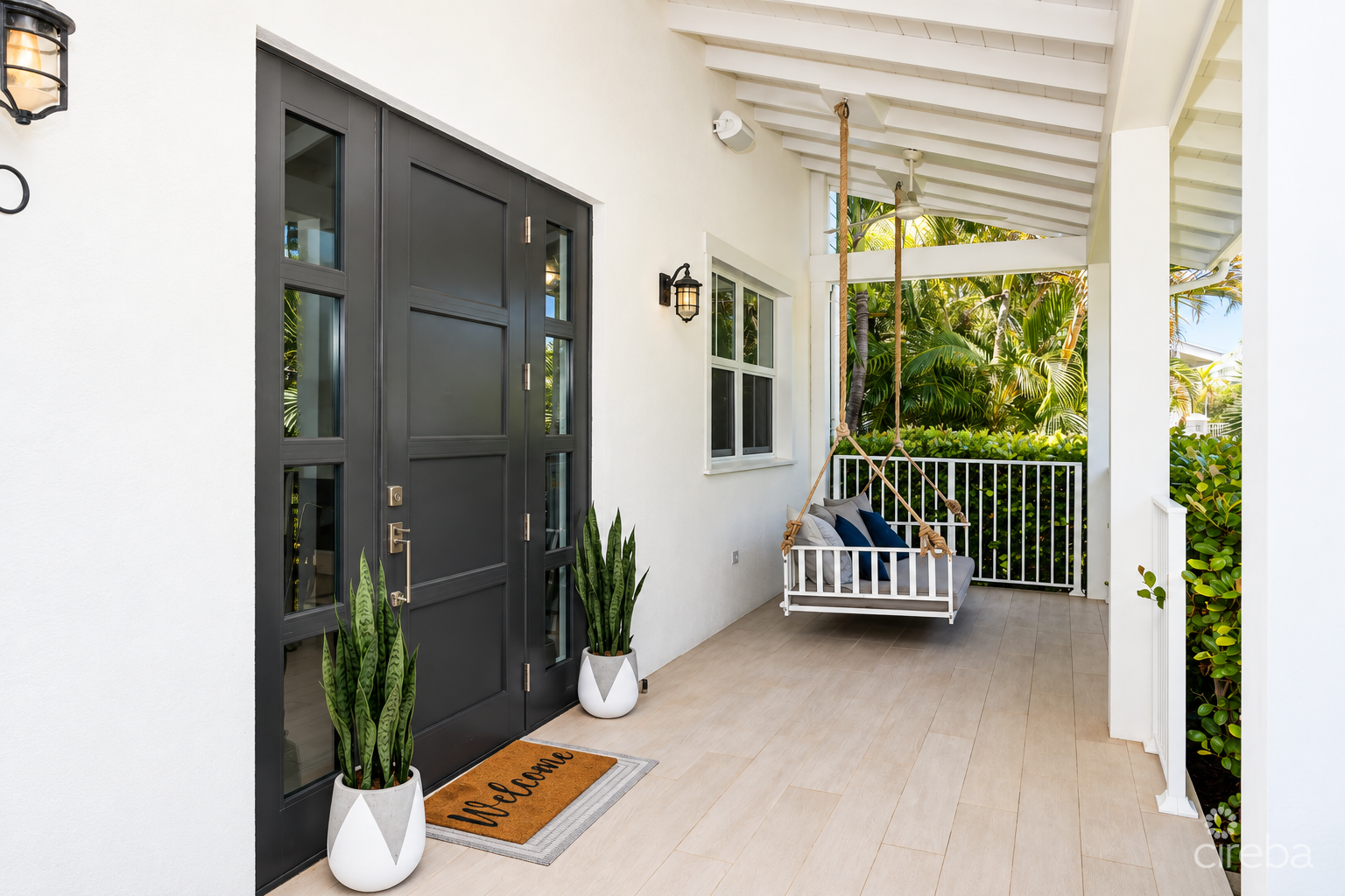 20261005143107 Bright Coastal Porch with Swing and Greenery
